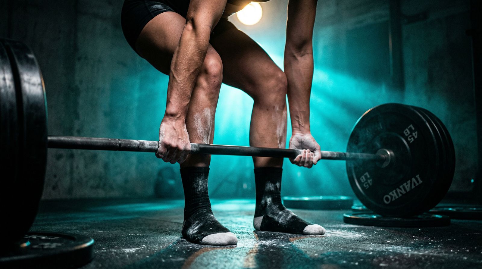 Athlete correcting deadlift form under teal cyberpunk gym lighting